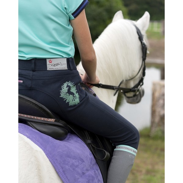 Lasten ratsastushousut, QHPIhanat lastenratsastus housut kolmella eri värillä. Takana on ihana hevonen paljeteilla ympyröitynä.